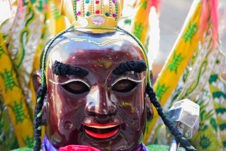 large decorative mask with ornate decorations on display