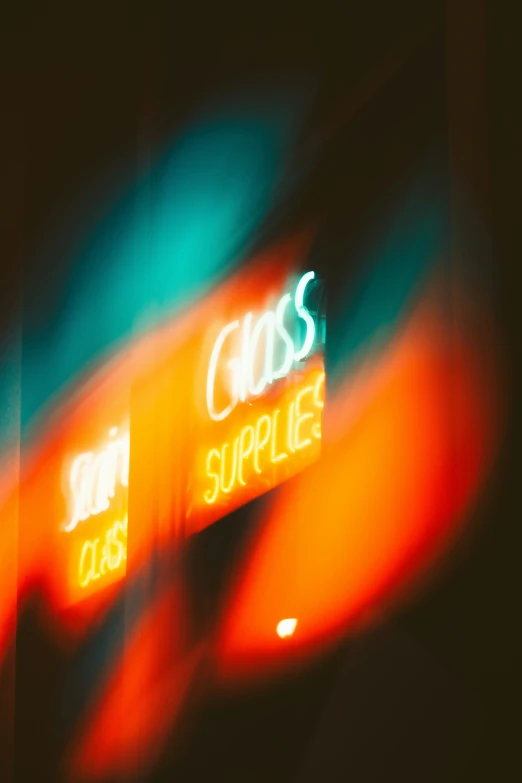 blurry pograph of neon signage on a building