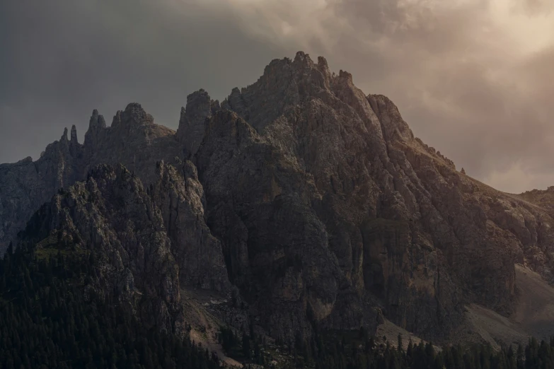 a group of mountains with clouds in the background