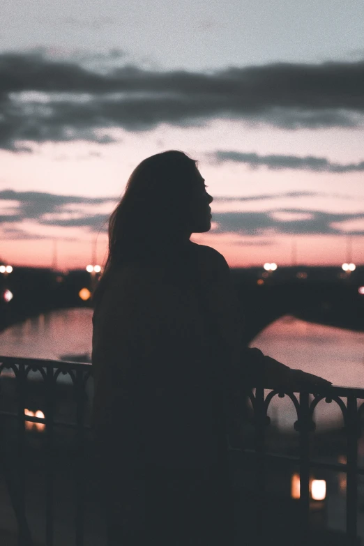 silhouette of a woman in front of a large cityscape