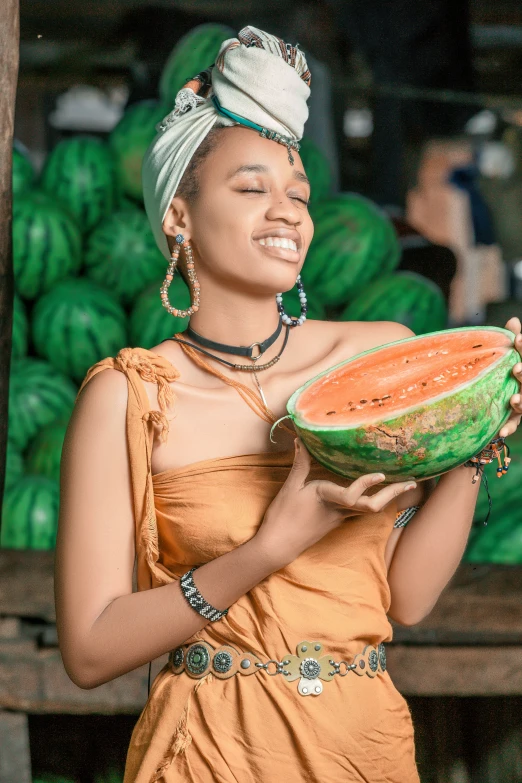 a woman is holding a watermelon in her hands