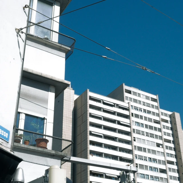 an office building behind some wire and a street sign