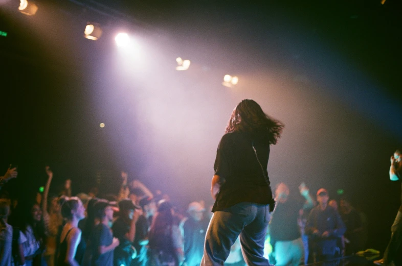 the concert scene is filled with people on stage