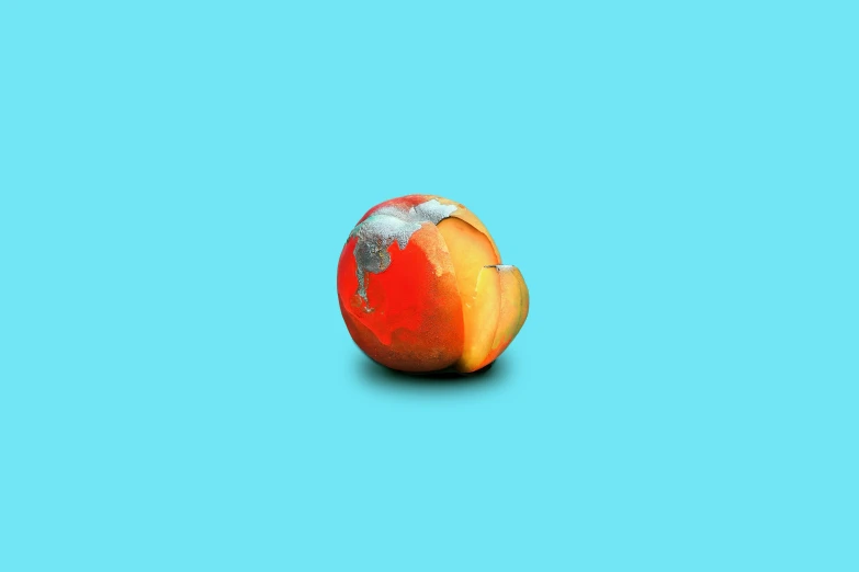 a peeled peach is sitting in the middle of a turquoise background