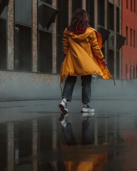 a person wearing a raincoat holding an umbrella