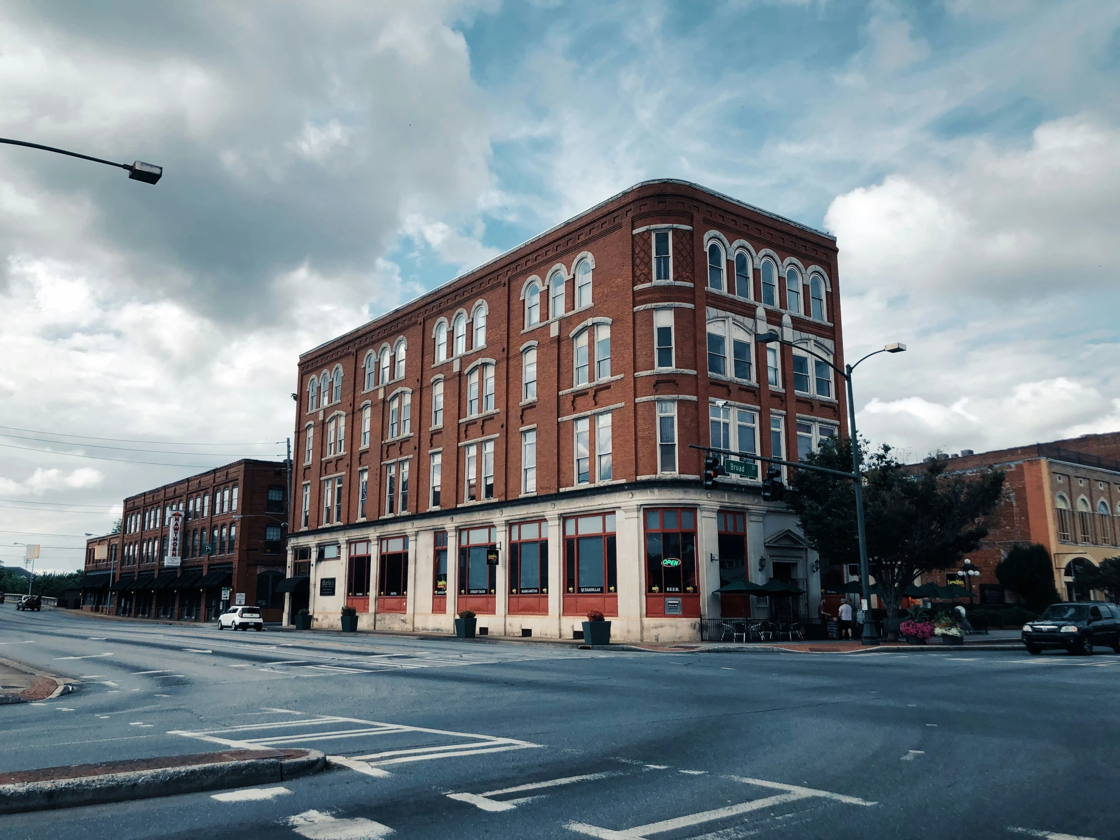 a three story brick building at an intersection