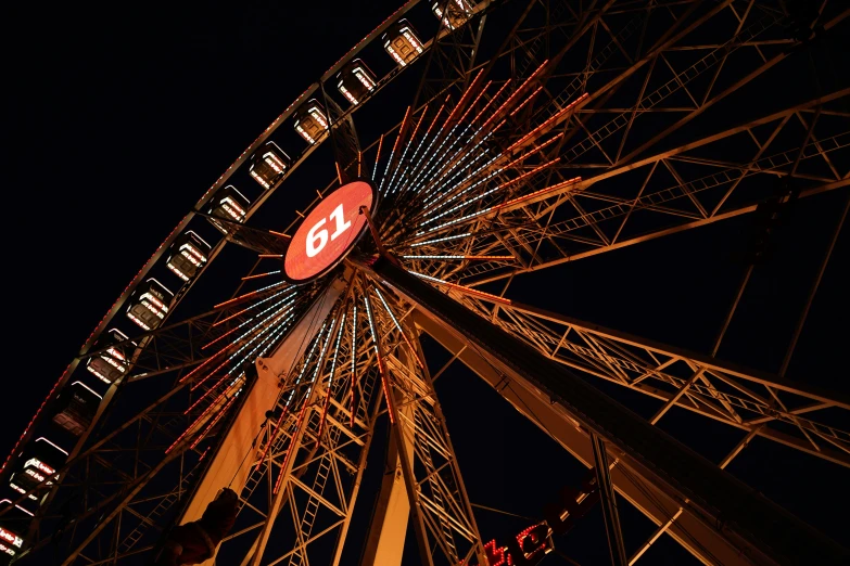 a ferris wheel is lit up at night time