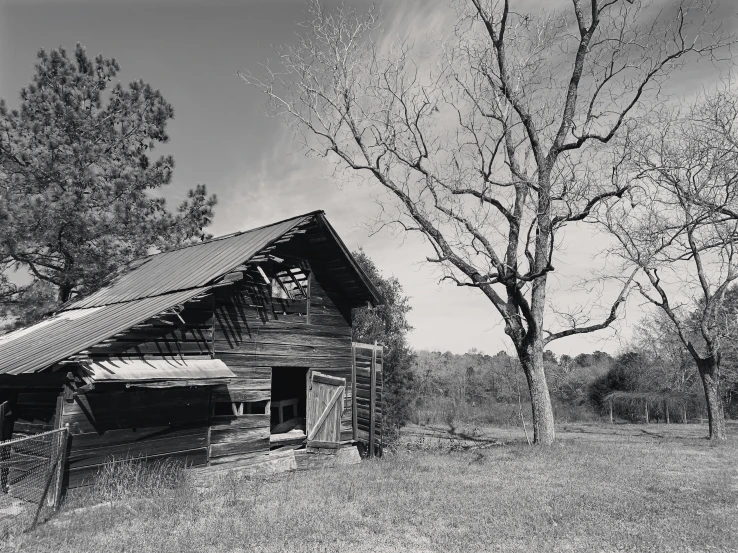 a small wooden cabin on the side of a grassy hill