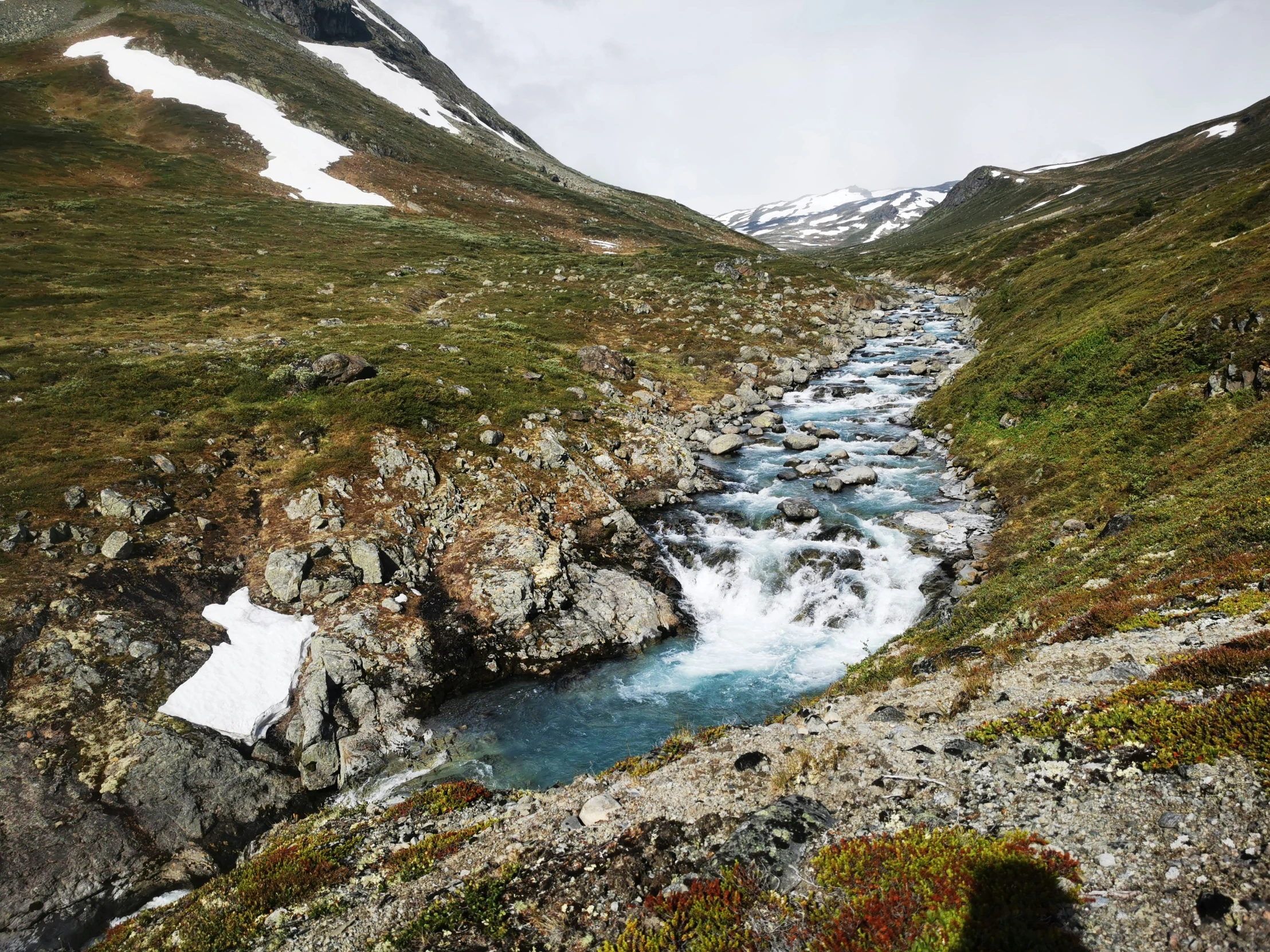 a waterfall running down the side of a mountain