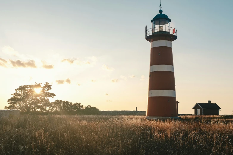 a lighthouse sitting on top of a lush green field