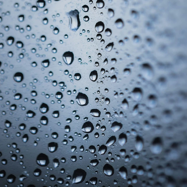 water drops that are hanging from the side of a window