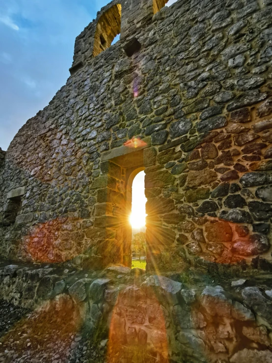 the sun is going through the windows of a tower