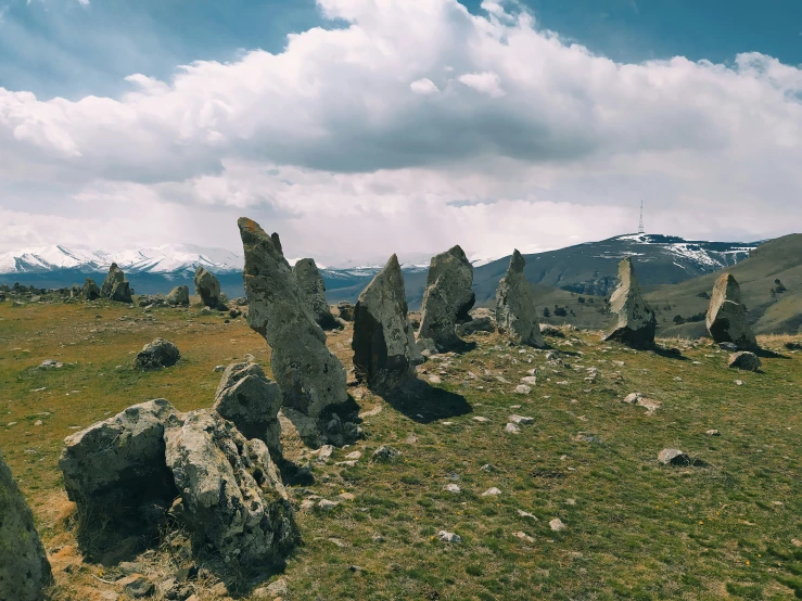 a rocky terrain with snow on the mountains