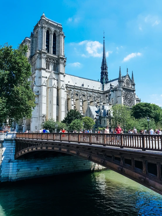 people walking on an outdoor walkway over water