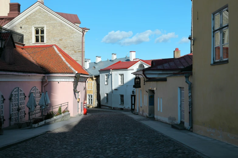 old stone street lined with red and white buildings