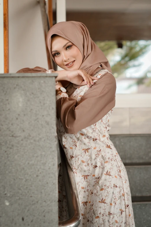 a woman posing for a picture while wearing a hijab