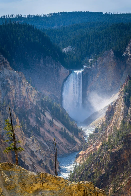 a waterfall is seen from a high up hill