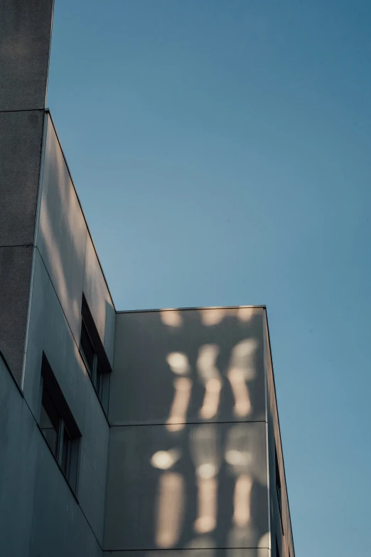 shadows cast on the building's exterior make a shadow