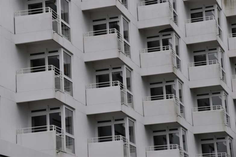 white building with balconies and a clock