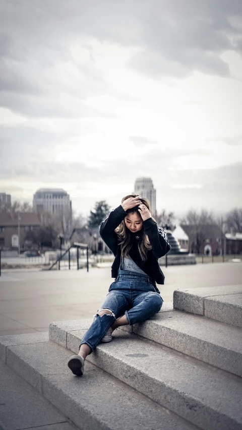 a woman posing on the steps and smiling