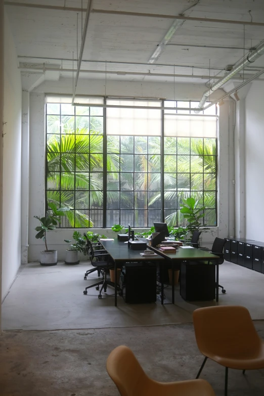 a large open space with two office chairs sitting at tables