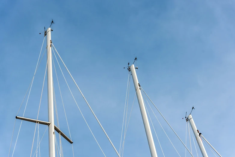 a line of white boats that are against a blue sky