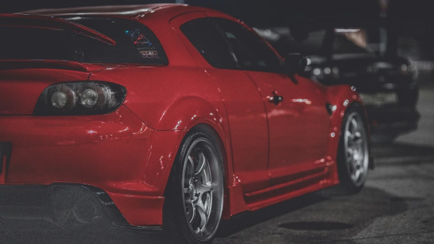 a red sports car parked outside of a building