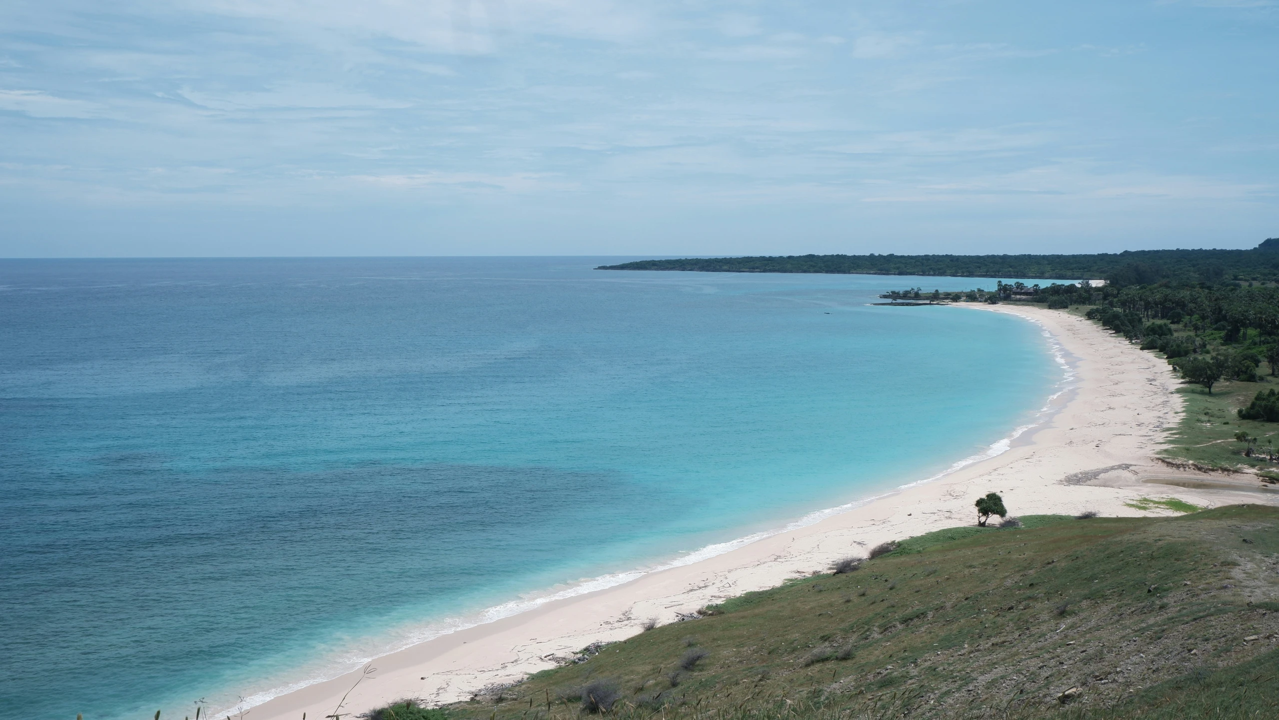 the beach is full of white sand and blue waters