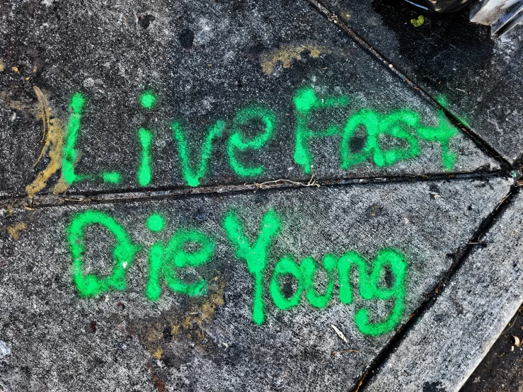the green words are on the sidewalk outside