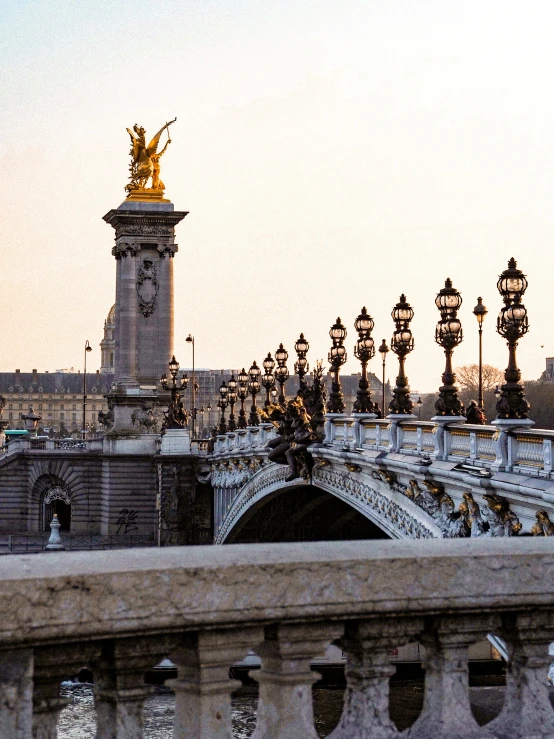 a bridge with street lights and a bridge behind it