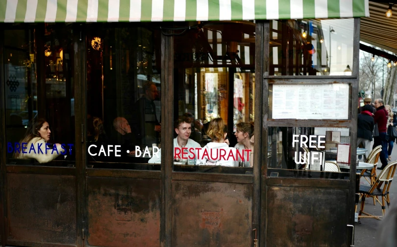 some people are holding signs out side a restaurant