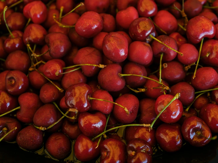 several bunches of cherries laying on top of each other