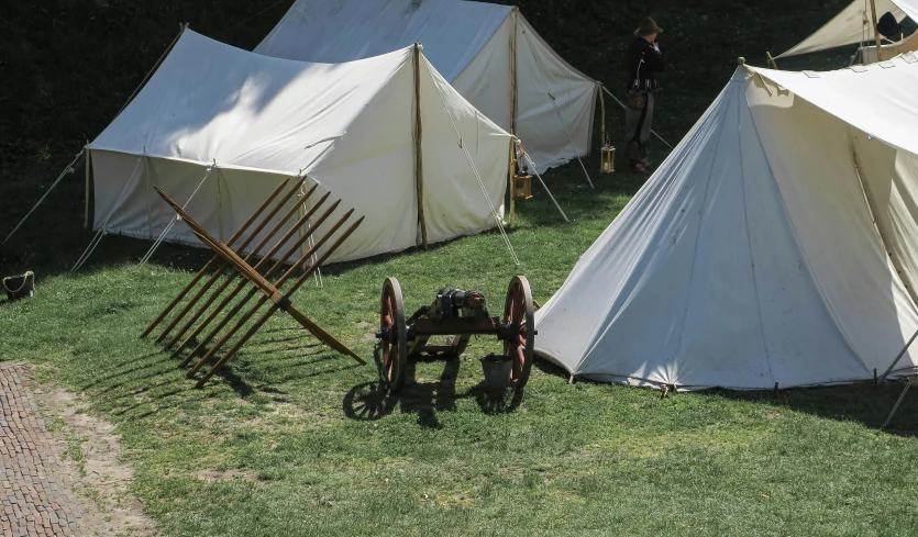 an image of two tents with wood poles