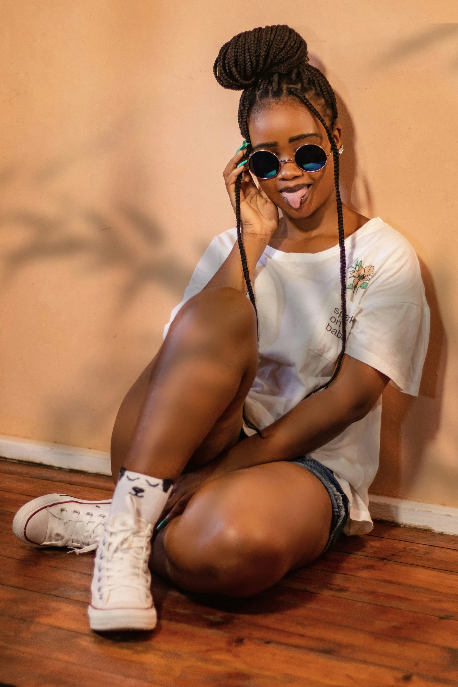 a woman sitting down on the ground holding a cell phone