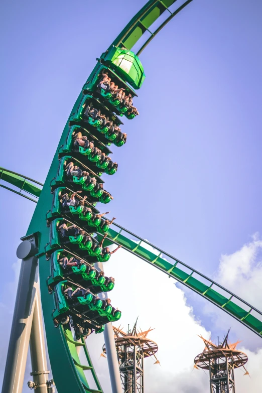 an amut park ride that has green and white cars