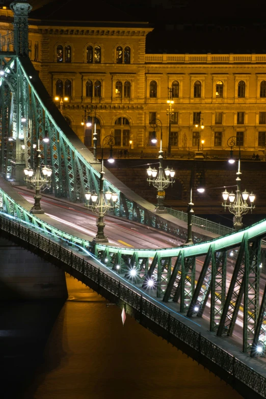 a long bridge that goes across a river next to a building