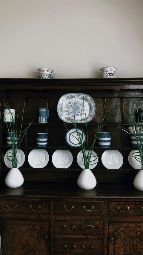 the vases are in front of the china cabinet