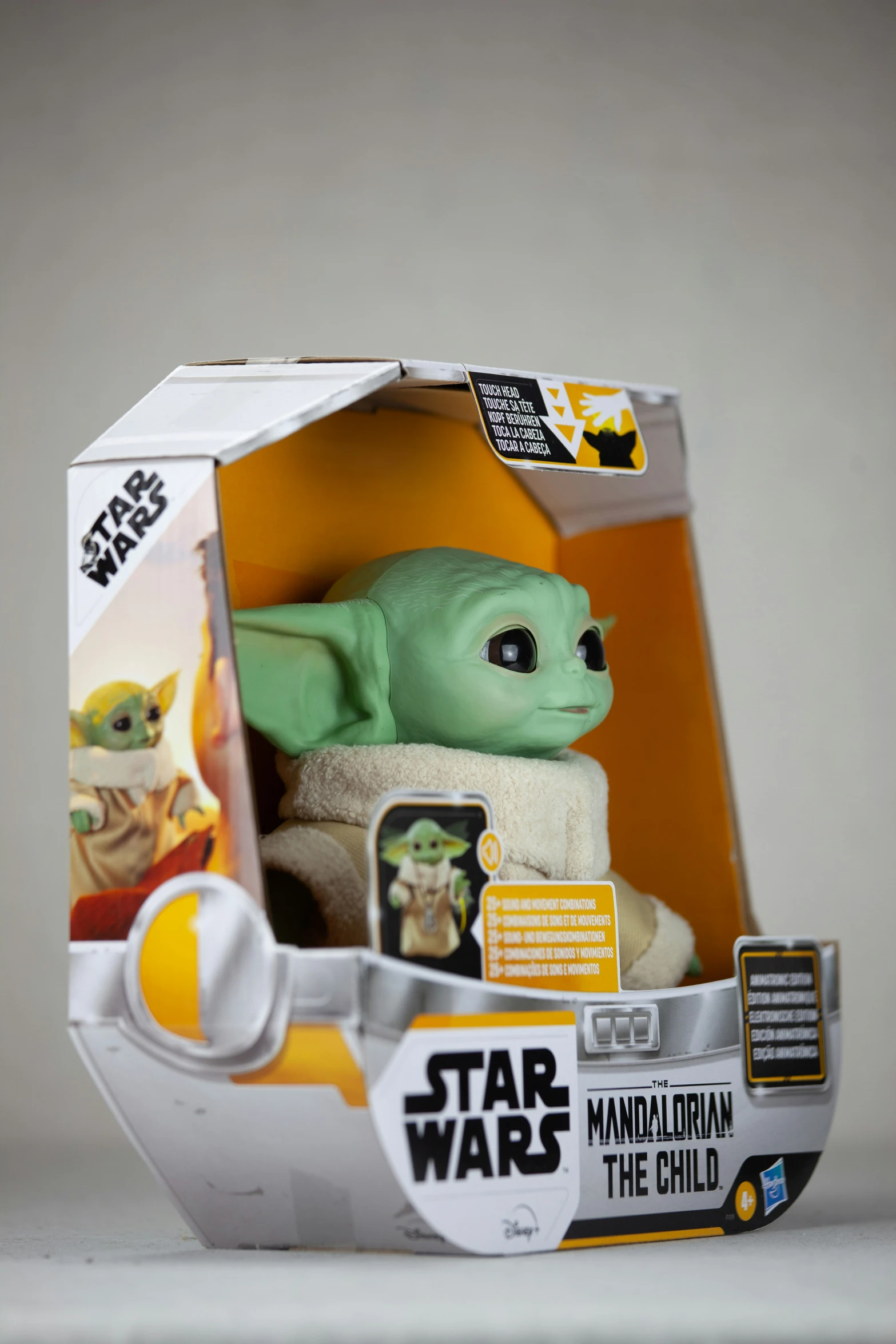 a baby yoda plush toy in a star wars packaging