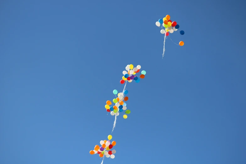 three kites that are being flown in the sky