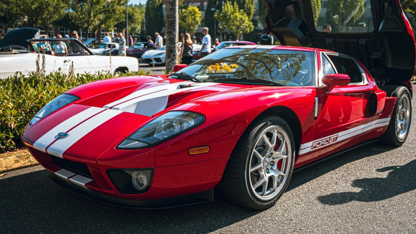 a red sports car with white stripes on its side