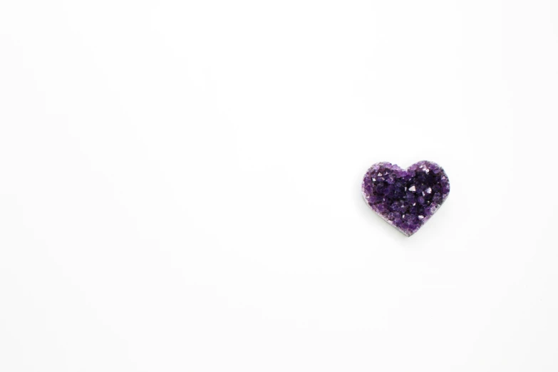a small purple object on a white background