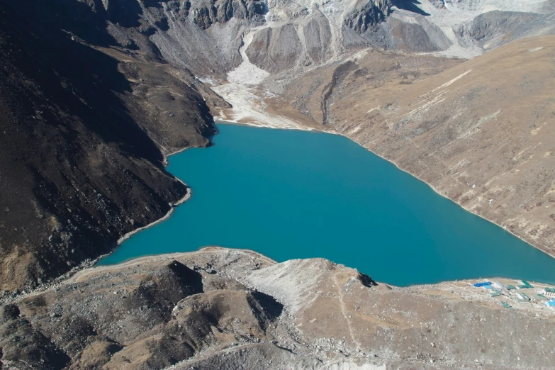 aerial view of a blue lake surrounded by mountains
