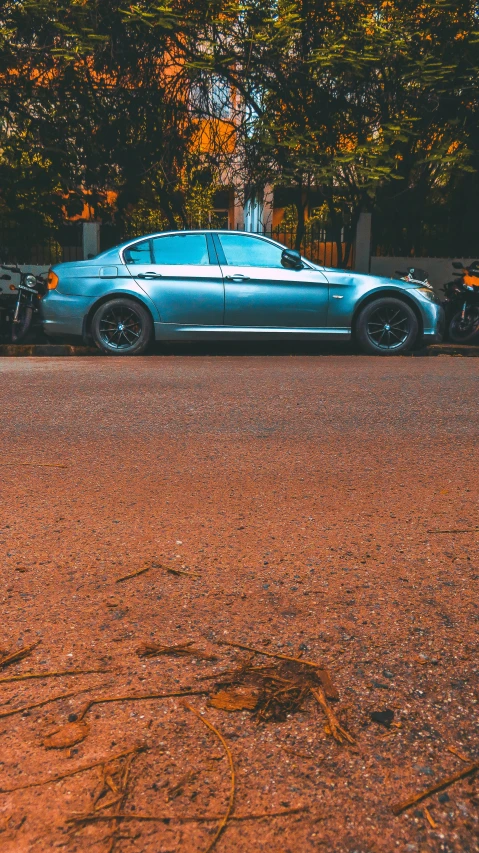 a car parked on the side of a road near trees