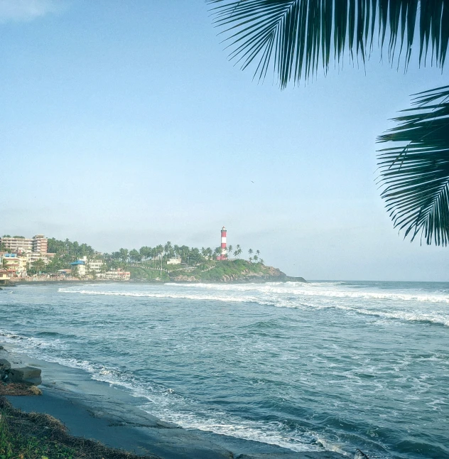 a beach that has a very large lighthouse on it