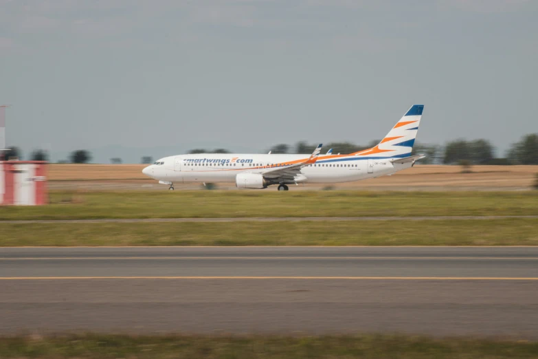 a large white airplane is going down the runway