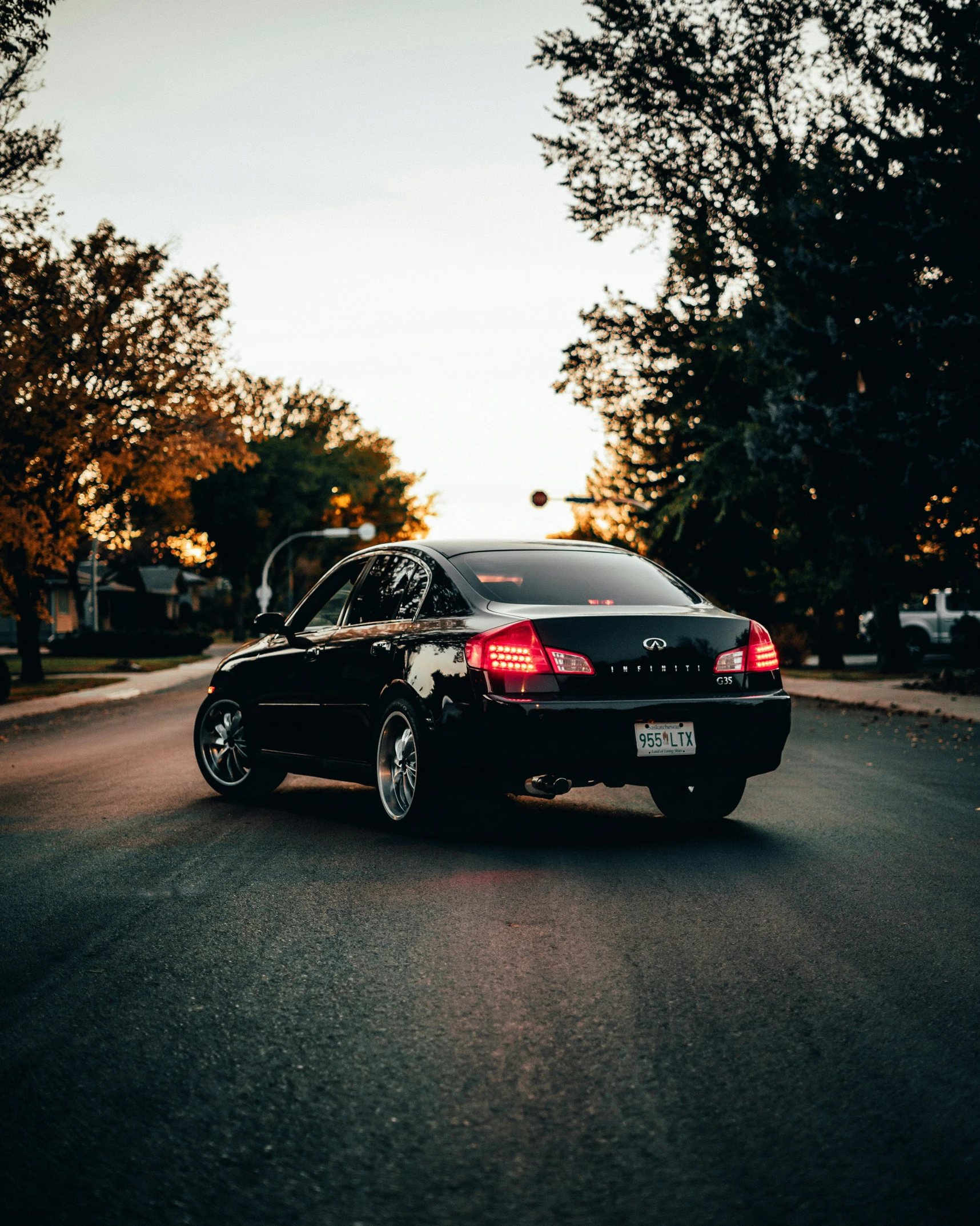 black car in middle of road with car taillights on