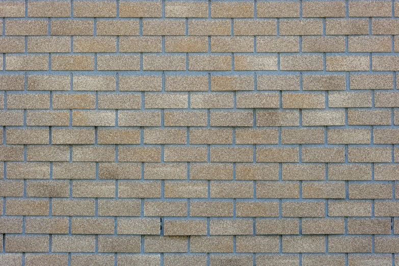 a close up of the side of a wall made of a brick pattern