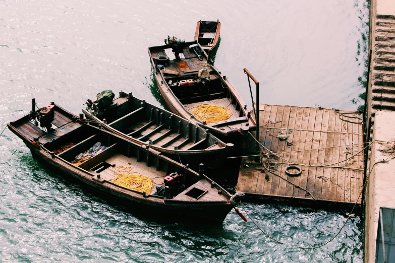 two boats that are parked on a dock