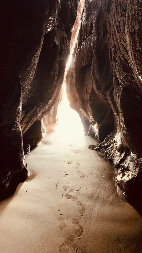 the light is coming through the rocks at the beach