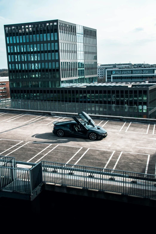 a parking lot with a vehicle parked next to a building